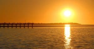 See scenic landmarks such as the Urangan Pier on the Champagne Sunset Sail cruise aboard luxury yacht Blue Dolphin.