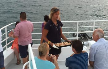 Graze on fresh seafood and enjoy the view on Whalesong's sunset and seafood cruise